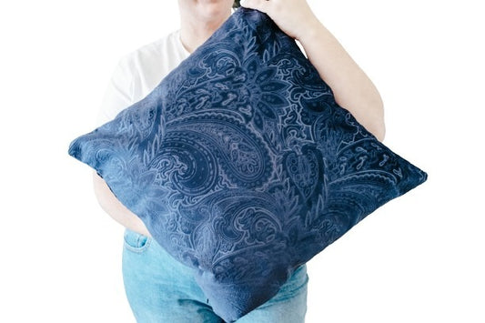 Person holding blue textured velvet cushion cover