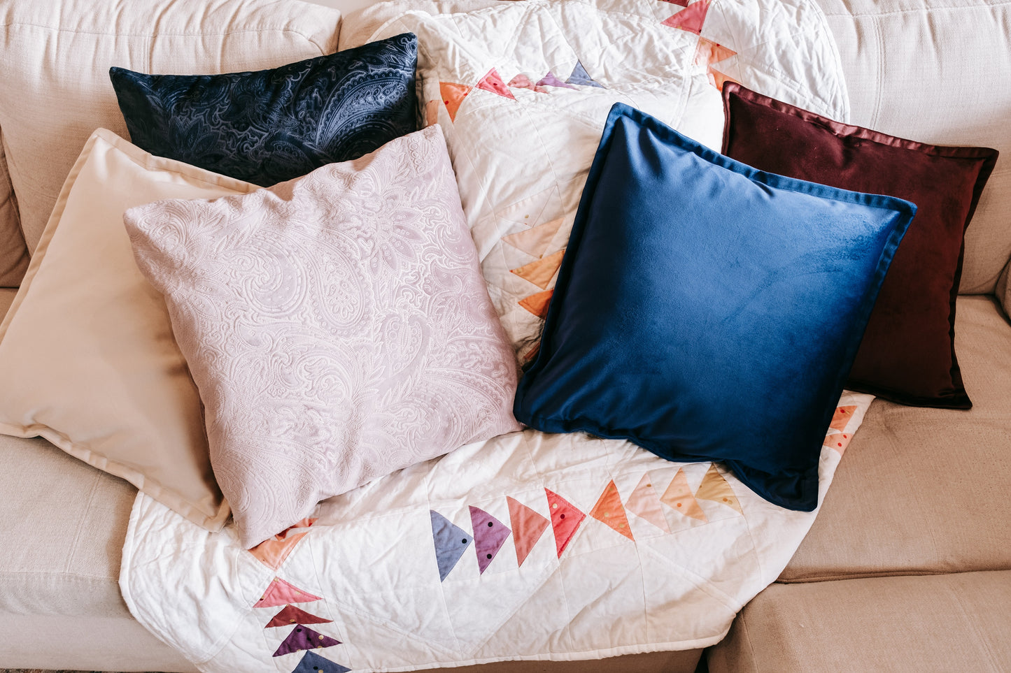 Lifestyle photo of blue textured velvet cushion cover on couch