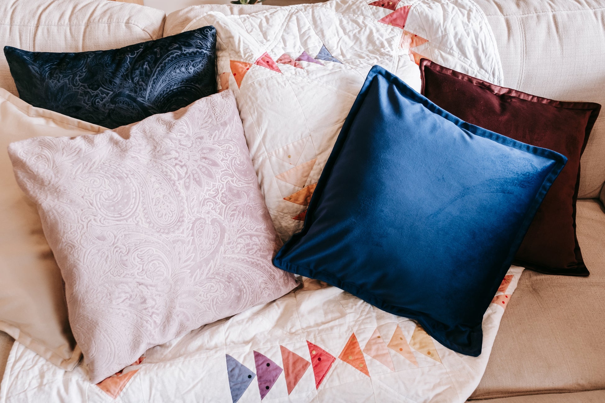 Lifestyle photo of velvet cushion cover with flange on couch