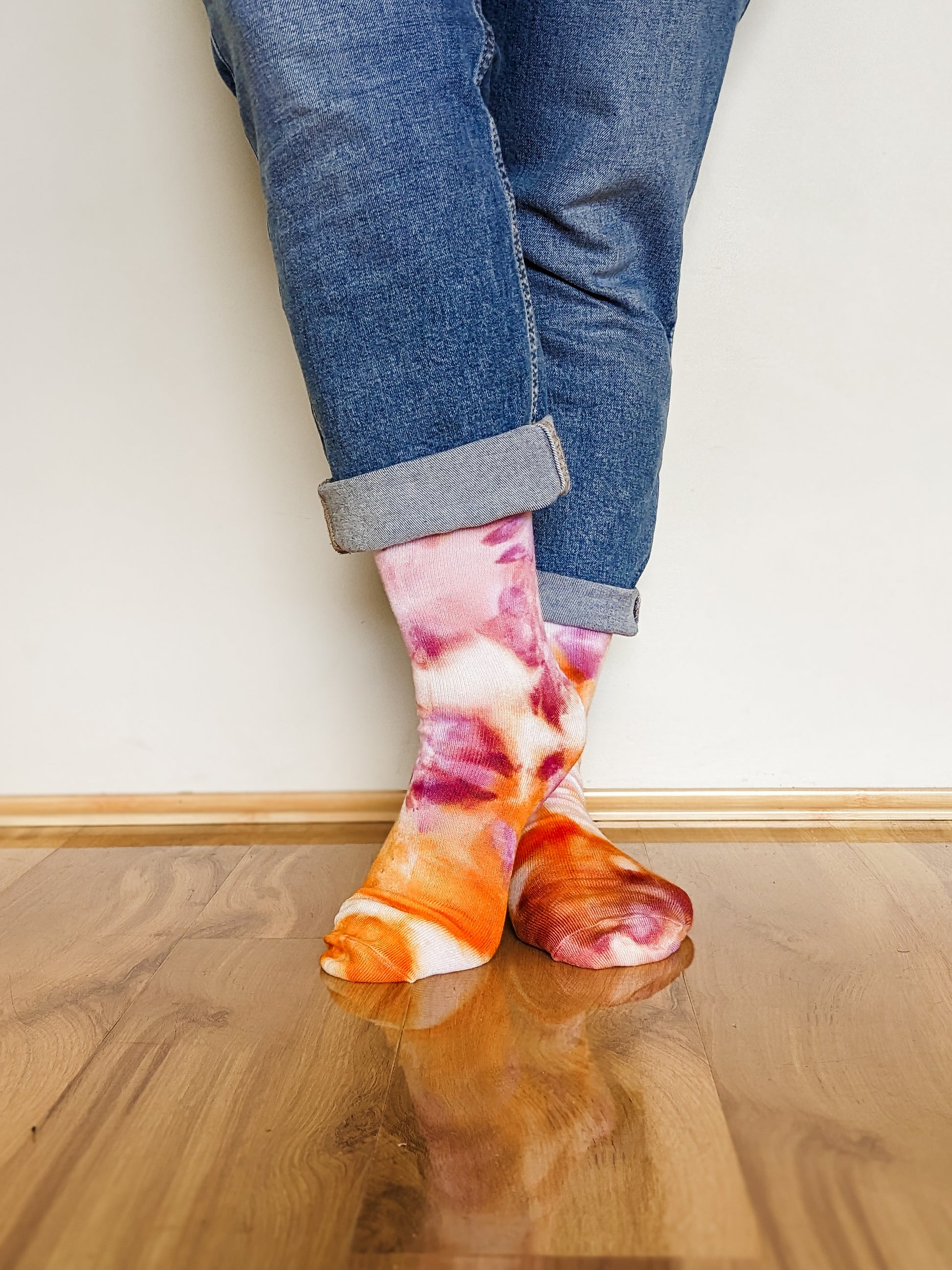 Person wearing crew length purple and orange Ice-dyed bamboo socks