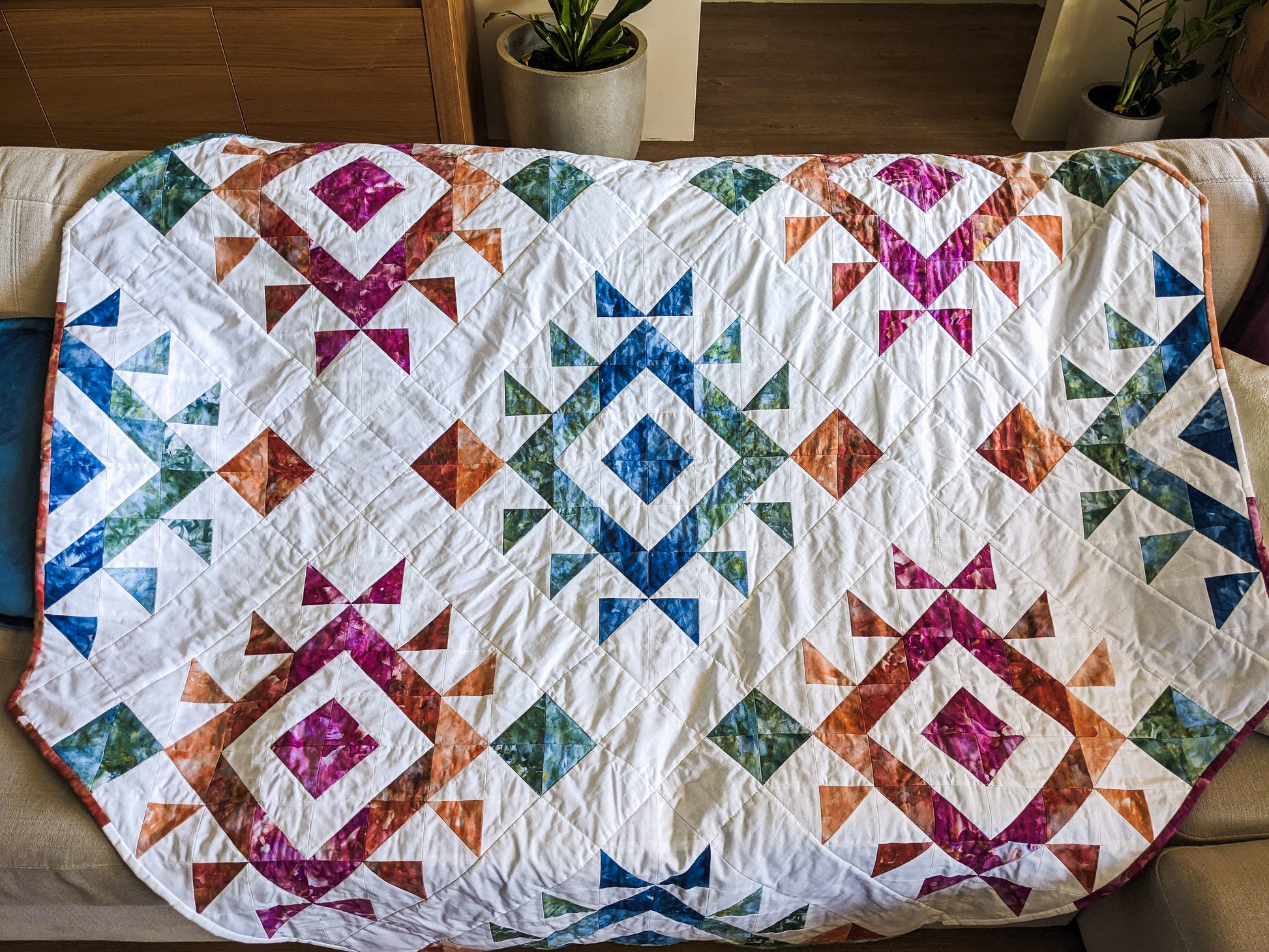 Close up of triangle handmade boho quilt with mink backing