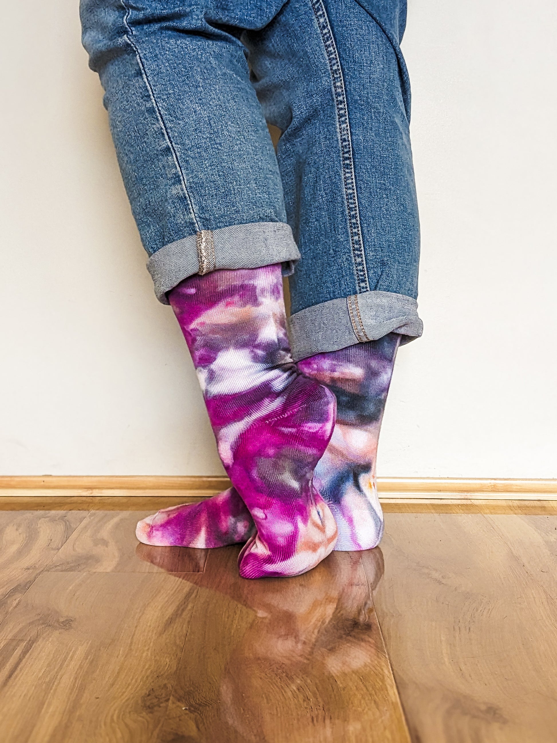 Person wearing crew length purple and black Ice-dyed bamboo socks